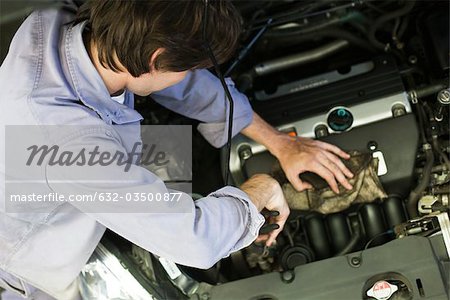 Mechanic repairing car engine