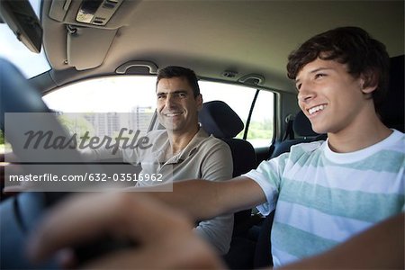 Father teaching his son to drive