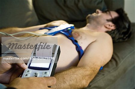 Doctor performing portable EKG (electrocardiogram) on patient in home
