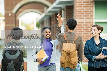 Classmates giving each other high-five