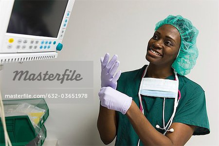 Nurse checking medical equipment monitor