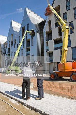 Building contractor discussing construction site with architect