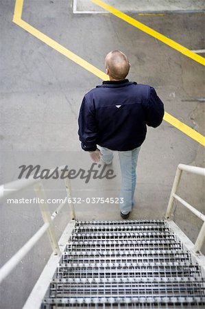 Man going down metal stairs