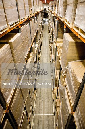 Warehouse filled with stacked pallets of cardboard boxes, elevated view