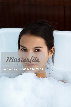 Woman relaxing in bubble bath, portrait