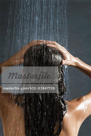 Woman washing her hair in shower