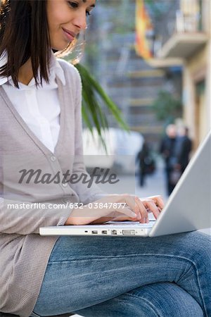 Woman using laptop computer outdoors