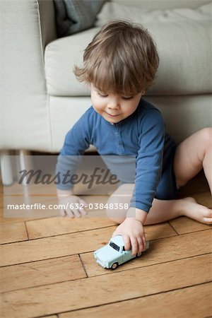Toddler boy playing with toy car