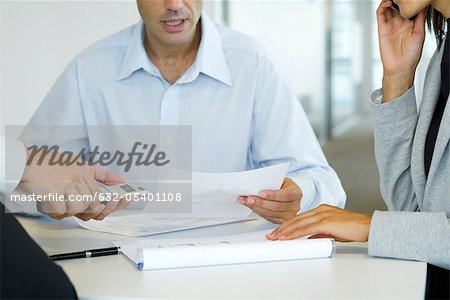 Executives discussing document