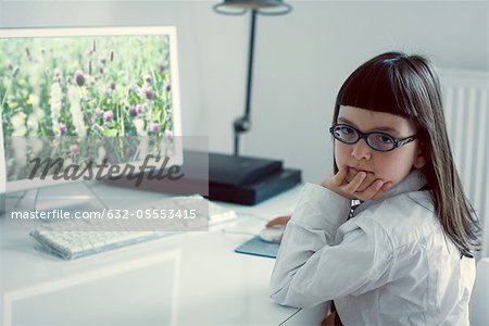 Girl sitting in front of desktop computer