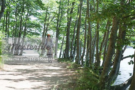 Woman riding bicycle in woods