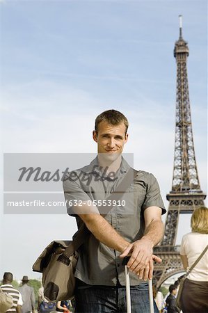 Man posing in front of Eiffel Tower, Paris, France