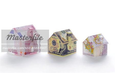 Model houses folded with different currencies