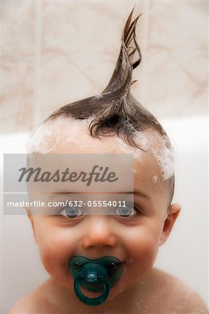 Little boy in bath with wet hair in mohawk, portrait