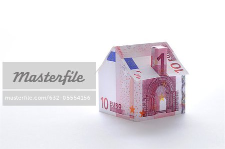 Model house folded with euro banknote