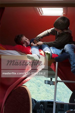 Boy tickling brother