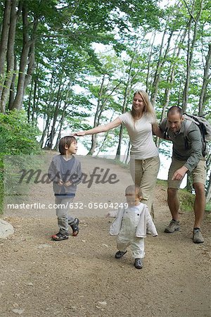Parents playing with children in woods