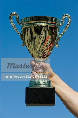 Man's arm holding up trophy
