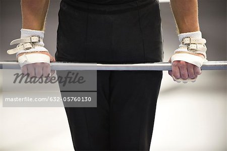 Gymnast on horizontal bar, cropped