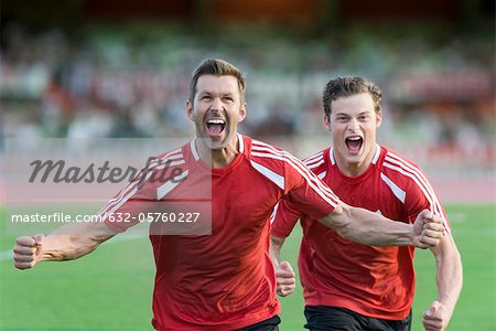 Soccer players shouting in victory