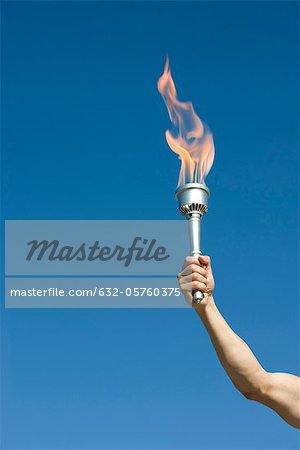 Man's arm holding up torch