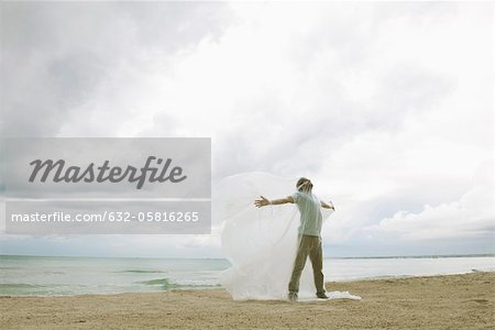 Man trapped in plastic on beach Man trapped in plastic on beach