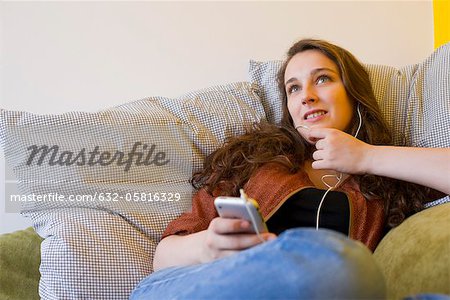 Young woman listening to MP3 player