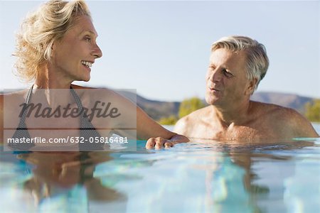 Retired couple soaking in pool
