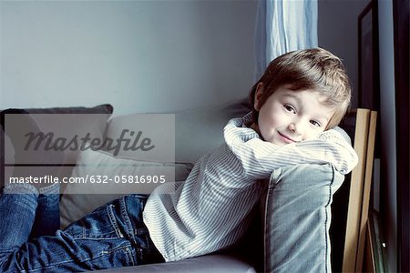 Boy relaxing on sofa, portrait