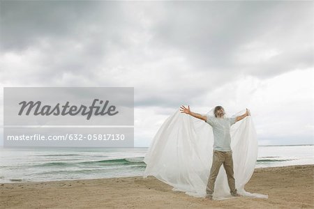 Man with arms outstretched trapped in plastic