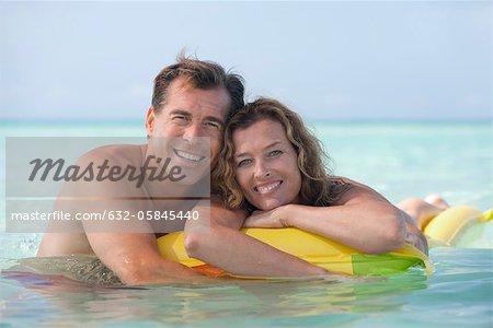 Couple relaxing in ocean, portrait