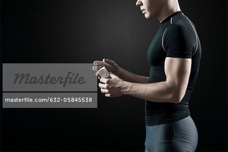 Male athlete applying chalk to hands