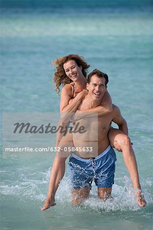 Young Man Giving Woman Piggyback Outdoors, Stock image