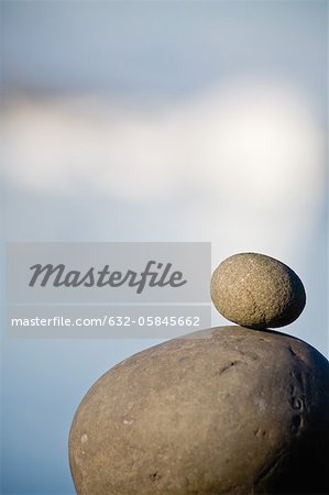 Small stone stacked on top of larger stone