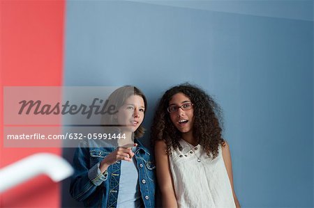 Young women gossiping together in hall