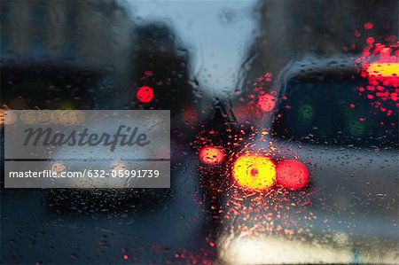 City traffic viewed through window during rain