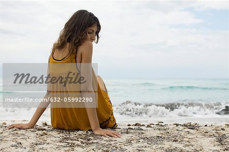 Young woman sitting on beach