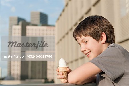 Boy holding ice cream cone, portrait