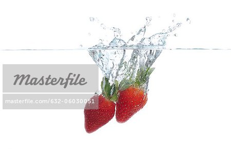 Strawberries splashing into water Strawberries splashing into water