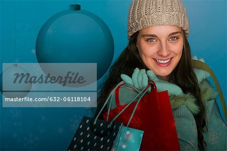 Young woman carrying Christmas shopping bags, portrait