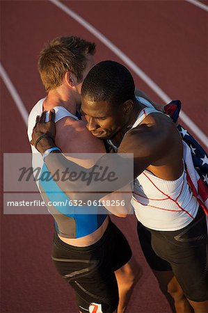 American running teammates embracing after race