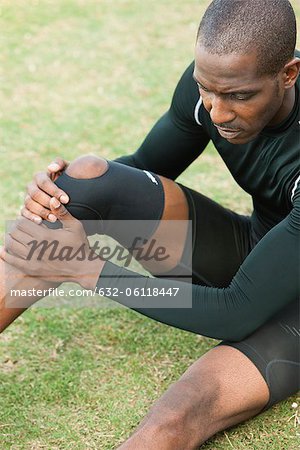 Male athlete wearing knee brace