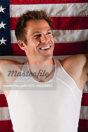 Smiling male athlete in front of American flag