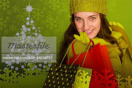Young woman carrying Christmas shopping bags, portrait