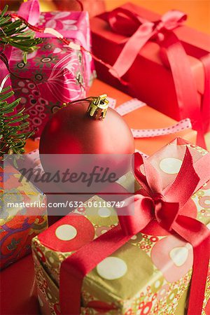 Christmas ornament resting on festively wrapped gifts