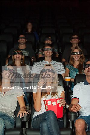 Audience wearing 3-D glasses in movie theater