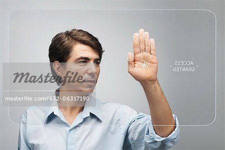 Man gaining access on touch screen interface using biometrics system