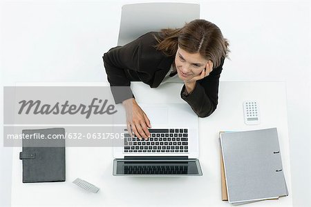 Businesswoman daydreaming at desk