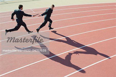 Businessmen running relay race