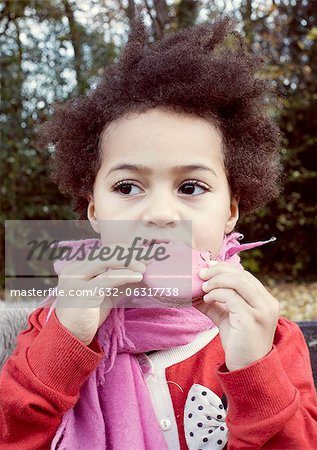 Little girl eating macaroon, portrait